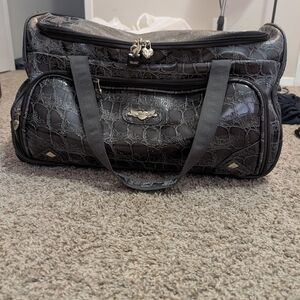 Kathy Van Zeeland wheeled travel duffel bag in a black crocodile-embossed finish